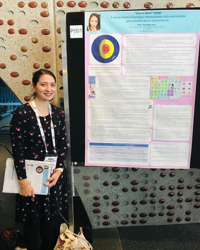 Robyn Fernandez-Baca standing with her Music Therapy conference poster to accompany her presentation