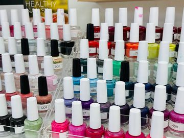 Rows of colorful nail polish bottles arranged neatly.