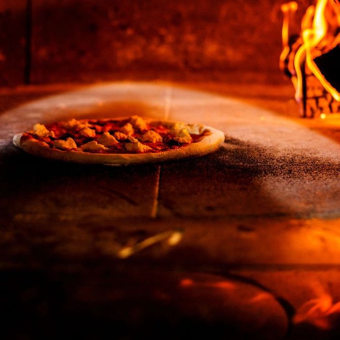 A pizza being cooked inside a pizza oven at a Mount Shasta Restaurant. 