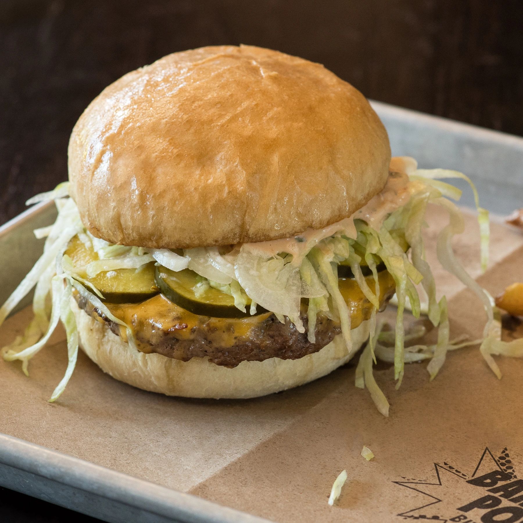 Bam Pow Burger, juicy burger, special sauce, housemande pickles, american cheese , potato bun!