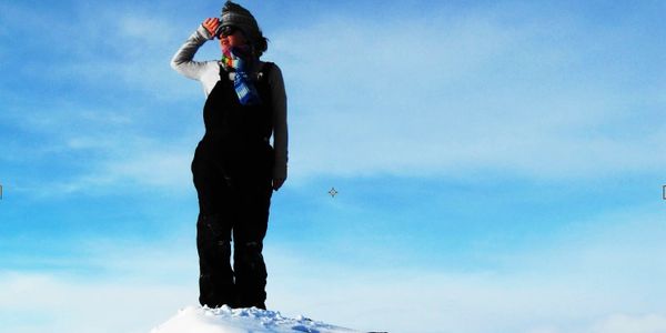 Woman standing on mountain.