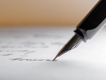 Close-up of a fountain pen writing on paper.