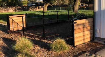 Metal fence with wire mesh to contain pets