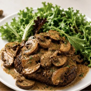 Steak with mushroom sauce and fresh greens.
