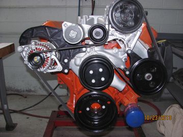 Close-up of an orange car engine.