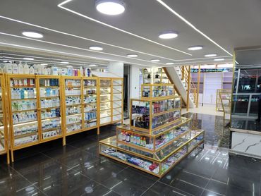 Bright, clean pharmacy interior with neatly organized shelves and modern lighting.