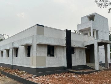 Newly constructed white building with modern design.