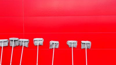 a picture of multiple booms against a red wall