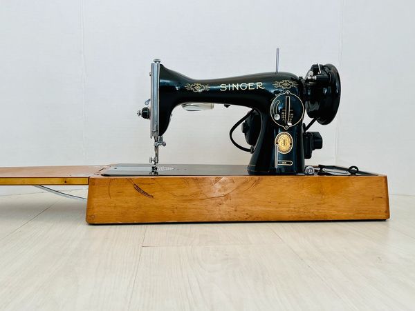 Traditional black sewing machine on a floor