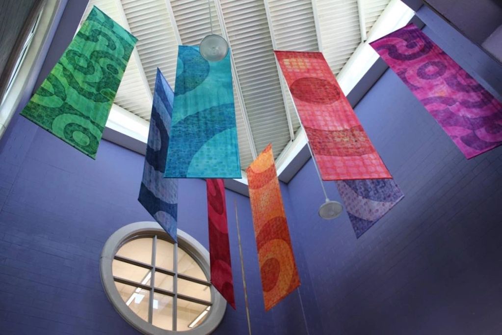 Brightly colored fabric banners hanging from ceiling