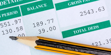 Payroll specialist processing employee payroll in QuickBooks accounting software.