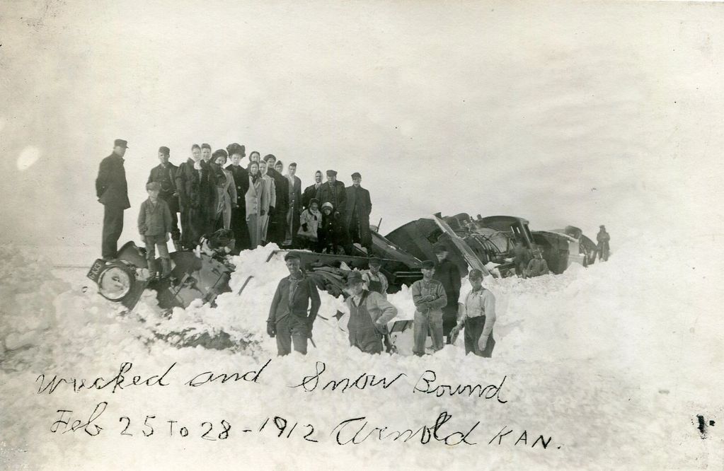 Picture says it all,  "Wrecked and Snow Bond February 25th to 28, 1912 Arnold Kansas". They are stan