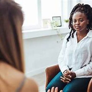 Woman attentively listening in a therapy session.