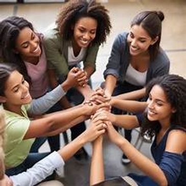 Group of women joining hands in unity.