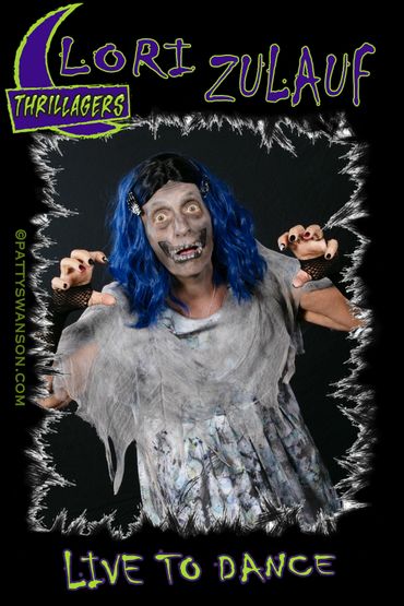 Person dressed as a zombie with blue hair in a spooky pose.