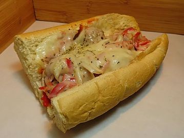 An open sandwich with melted cheese