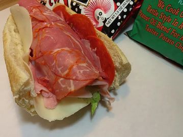 An open sandwich with meat and cheese