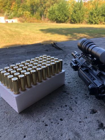 .223 Rem and Firearm pictured at the long range shooting bench at a firing range.
