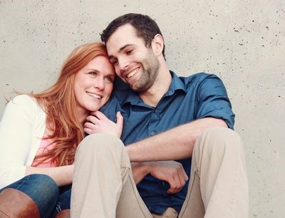 Photo of a man and woman sitting beside each other smiling