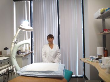 the laser girl in a treatment room at her skin care clinic