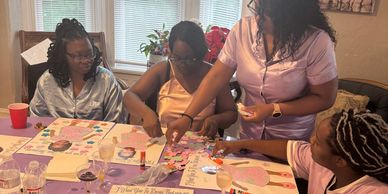 Group enjoying a painting session at a table.