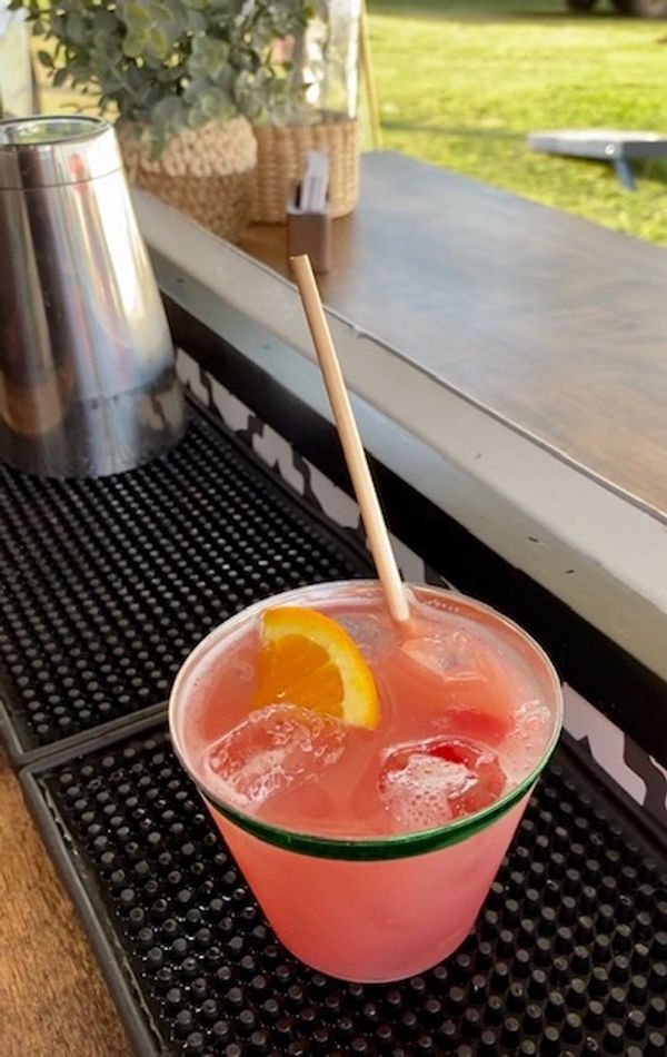 cocktail sitting on bar in horse trailer 