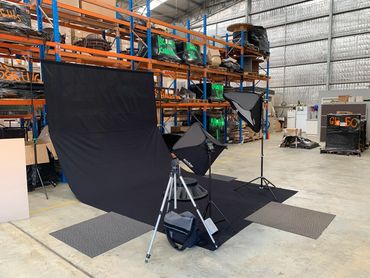 Setting up mobile studio with black back drop for product photography