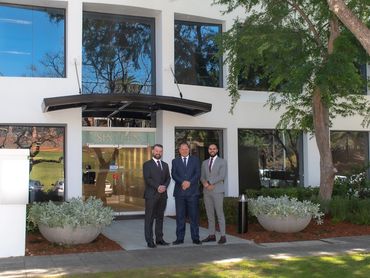 photo of management team in front of new premises