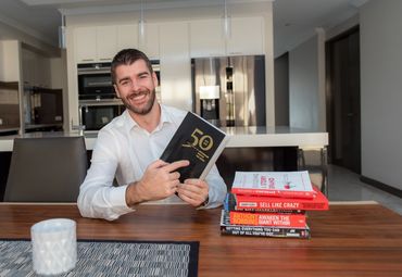 promotional marketing photo of business consultant with books