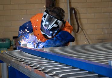 Corporate branding photoshoot photo of welding steel fencing