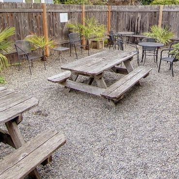 Outdoor tables and umbrellas at Greeley Avenue Bar Portland