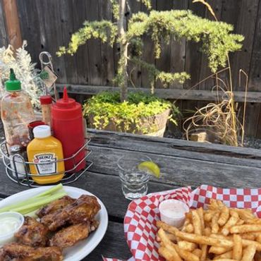 Outdoor patio seating with picnic tables Greeley Avenue Pub Portland"
