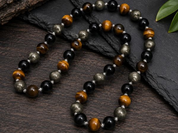 Beaded necklace with black, brown, and metallic beads.