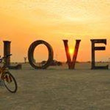 Large LOVE letters with sunset and bicycle.