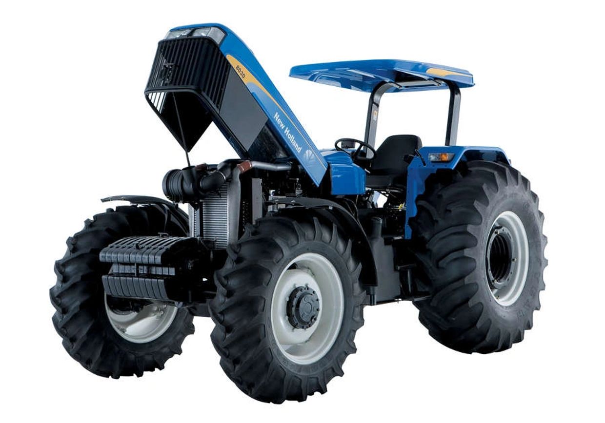 Blue New Holland tractor with open hood showing engine details.