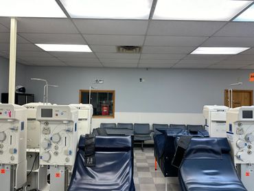 Dialysis treatment chairs and machines in a clinical room.