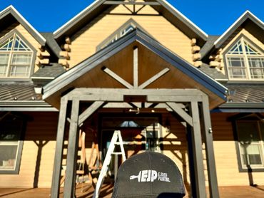 Black cap with 'EJP Ejireh Painting' in front of a house under renovation.