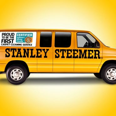 Yellow Stanley Steemer carpet cleaning service van with certification logo.