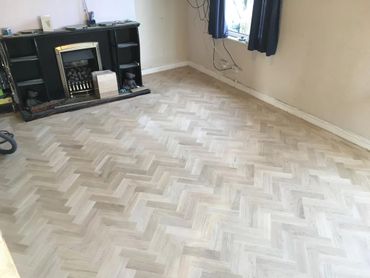 A fully installed parquet floor, ready to be sanded and sealed