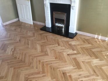 Another angle of the completed herringbone parquet flooring, fully sanded and sealed