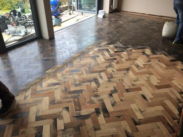 Part way through the sanding process of the reclaimed hardwood floor installation