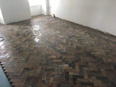 Almost there! A reclaimed pitch pine parquet block floor installation in Anglesey, North Wales.