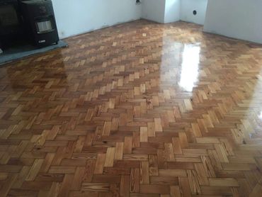The finished installation of a reclaimed pitch pine parquet block floor