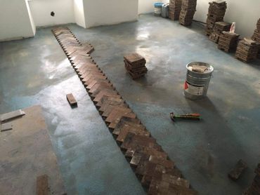 The start of a reclaimed pitch pine parquet block floor installation