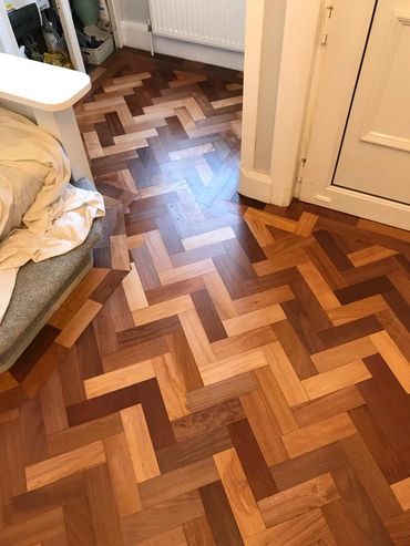 The finished reclaimed wood parquet flooring