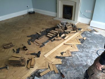 The first stage of the parquet floor repair and renovation