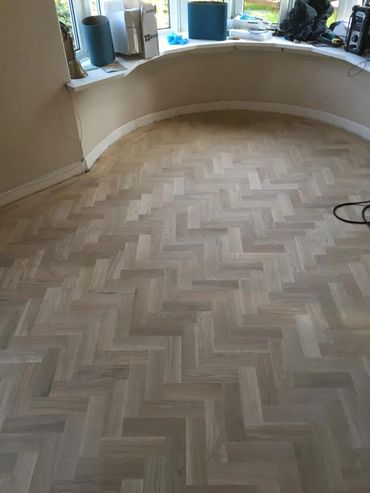 A fully installed parquet floor, ready to be sanded and sealed