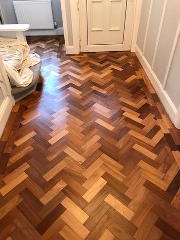 The finished reclaimed wood parquet flooring