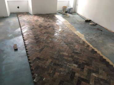 Half way through a reclaimed pitch pine parquet block floor installation