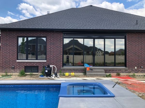 Residential window tinting in Windsor- Essex County Ontario showing reflective window film on home W